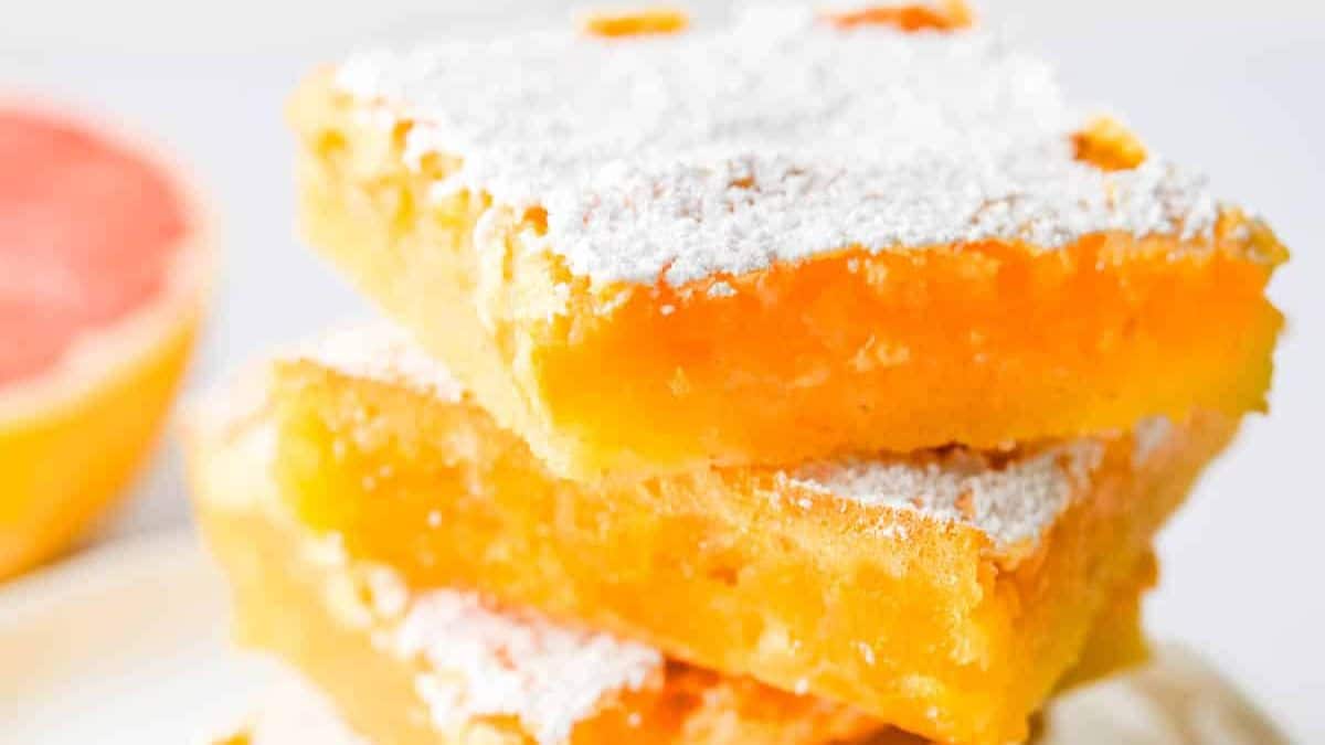 Stack of pink grapefruit dessert bars.