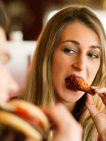 woman eating wings at a restaurant