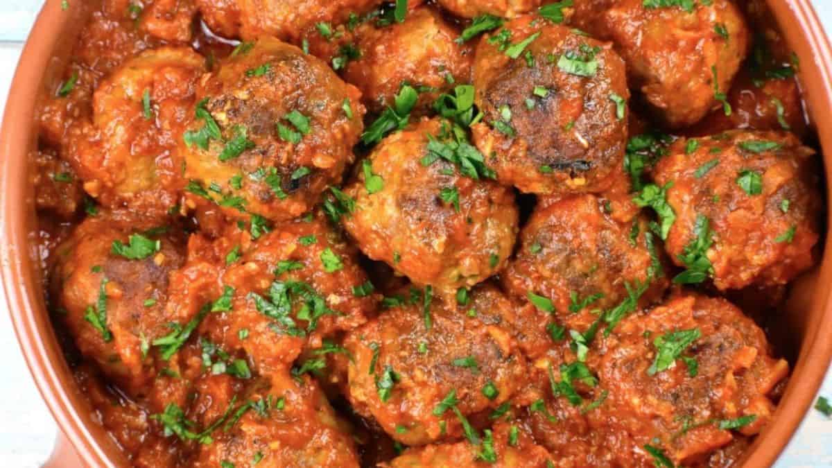 Freshly cooked albondigas or Spanish meatballs garnished with fresh parsley.