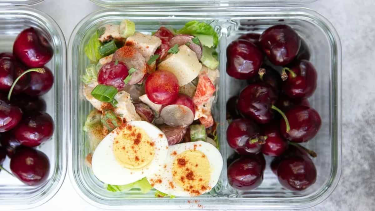 Chicken potato salad with egg, grapes, and celery.