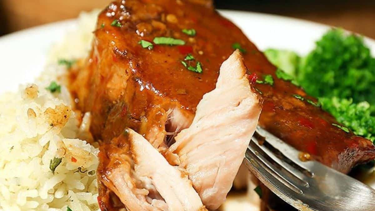 Crock pot pork chops with gravy served with rice.