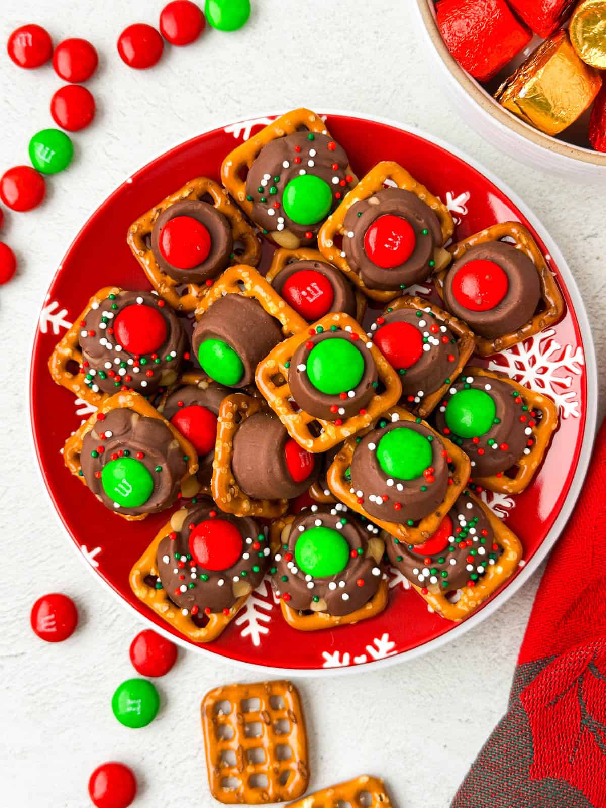 Christmas Rolo Pretzel Bites in a Christmas themed plate.