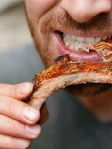 Man face eating ribs