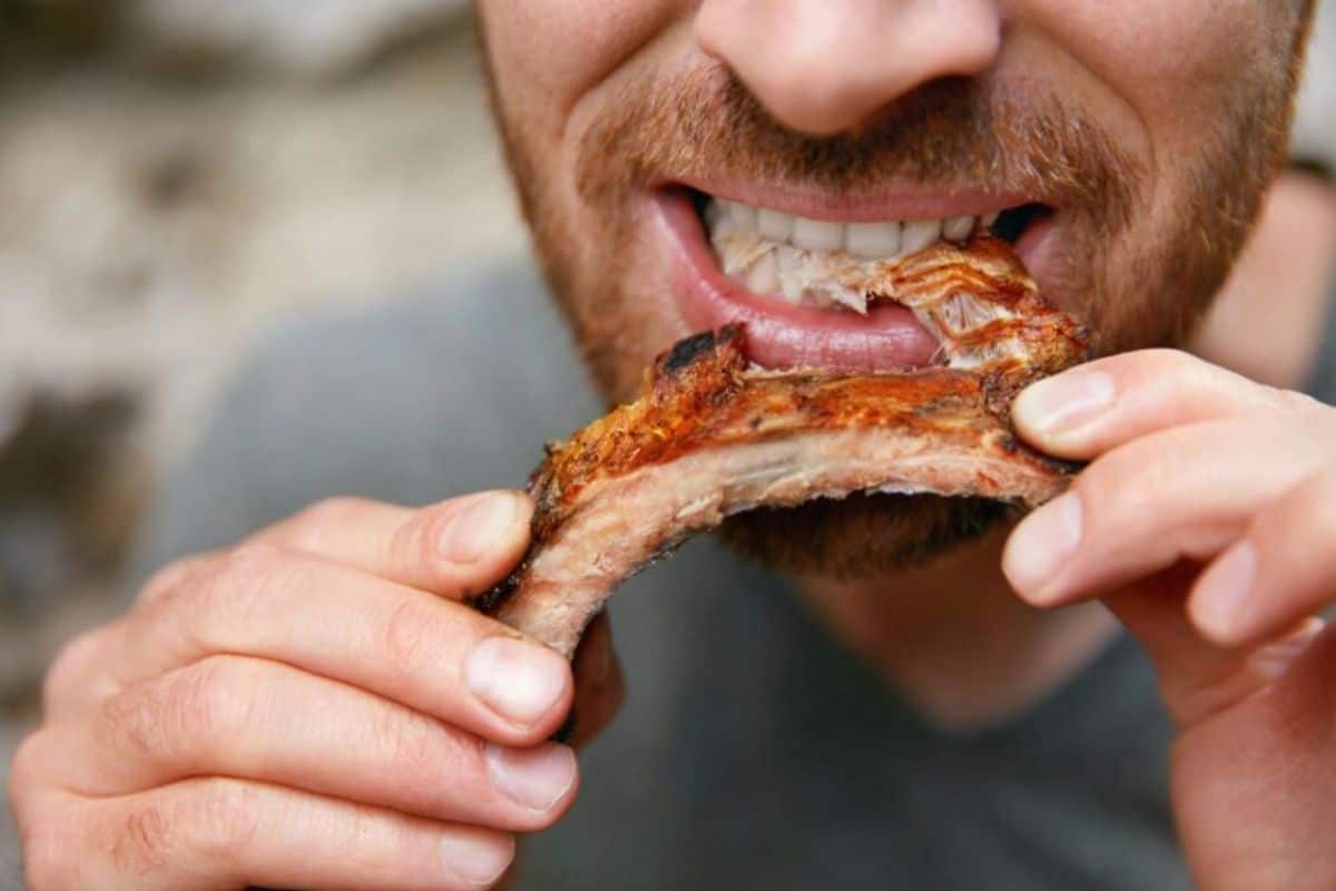 Man face eating ribs