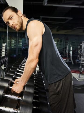 Man holding weights over a rack