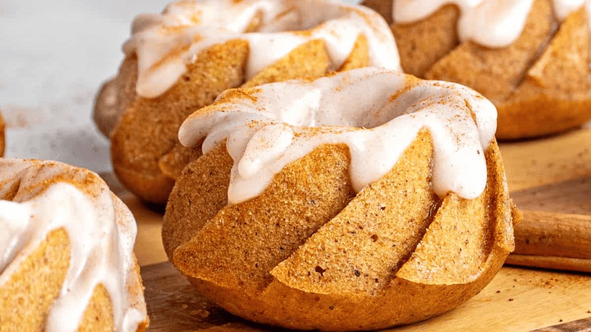 Perfectly plated mini pumpkin bundt cakes with cinnamon glaze.