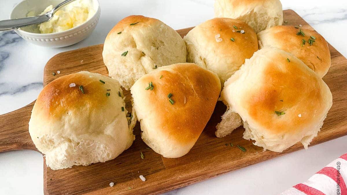 Freshly baked old fashioned yeast rolls with butter on the sides.