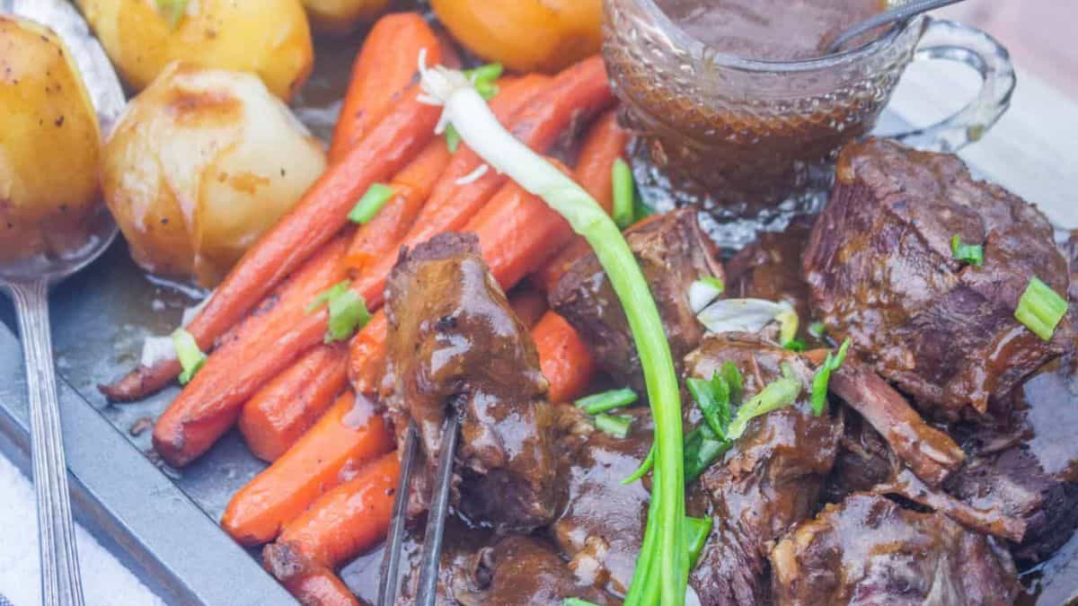 Freshly cooked old fashioned pot roast with vegetables and gravy.