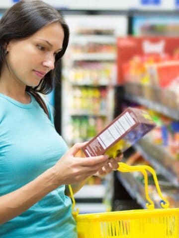 Woman looking at a label at the grocery store