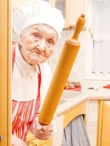 grumpy grandma in the kitchen with a rolling pin