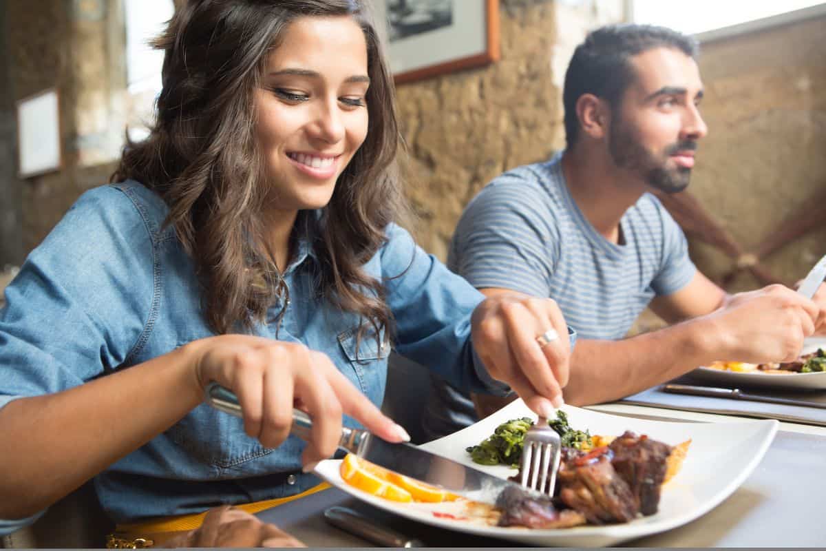 woman eating at a restaurant smiling