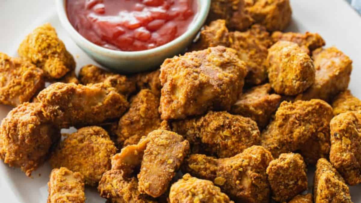 Freshly cooked air fryer tofu nuggets with dipping sauce.