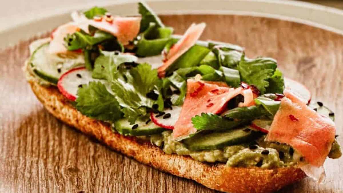 Asian-inspired avocado toast in a rustic-themed presentation.