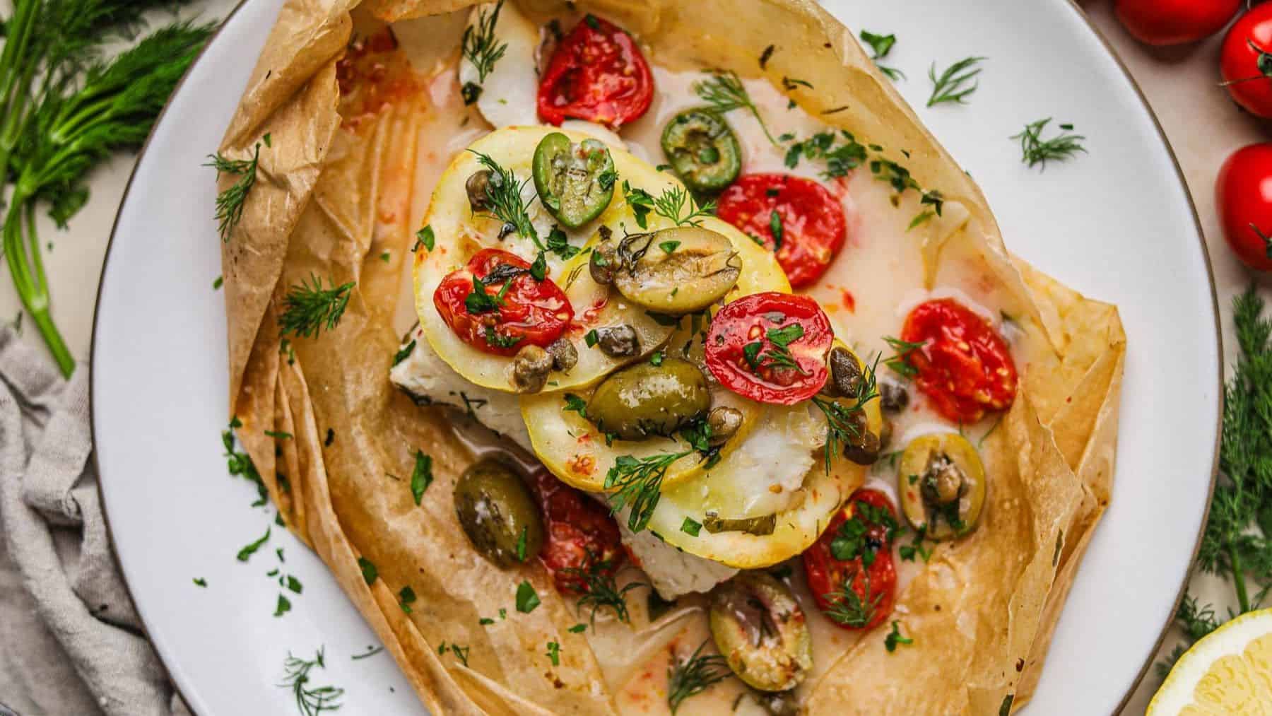 Freshly baked cod on a parchment paper.
