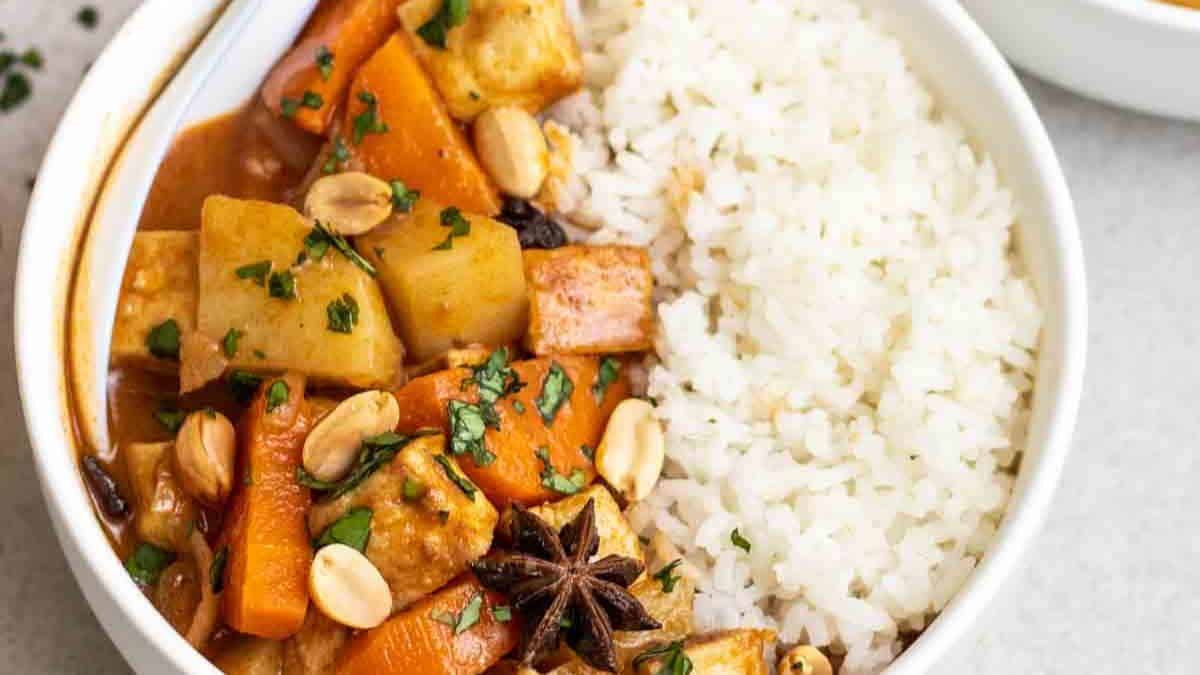 creamy vegan massaman curry with tofu and rice,
