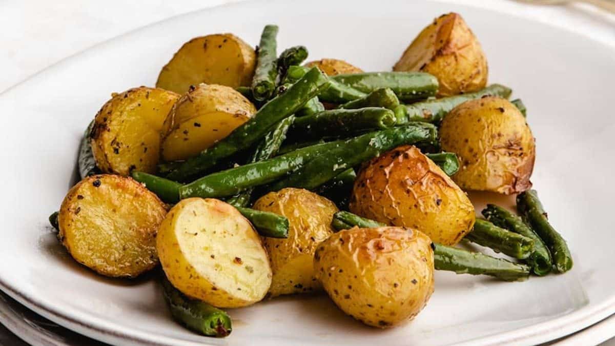 A plate of roasted potatoes and green beans.