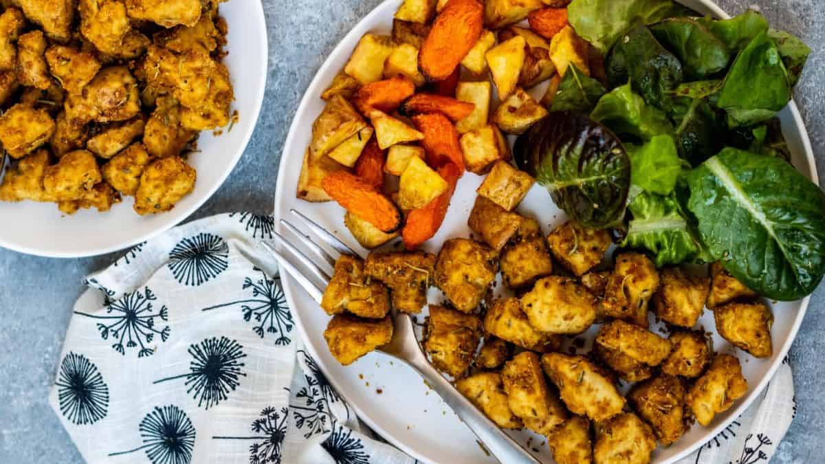 Rosemary tofu with nutritional yeast and veggies on the side.