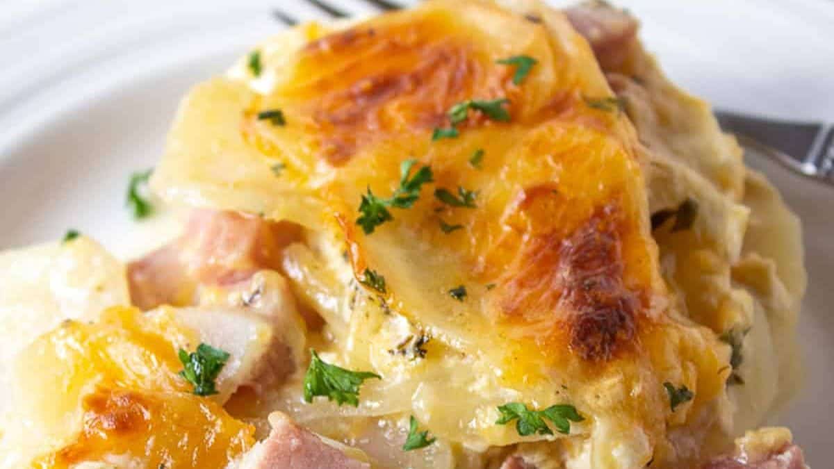 Scalloped potatoes and ham garnish with fresh parsley.