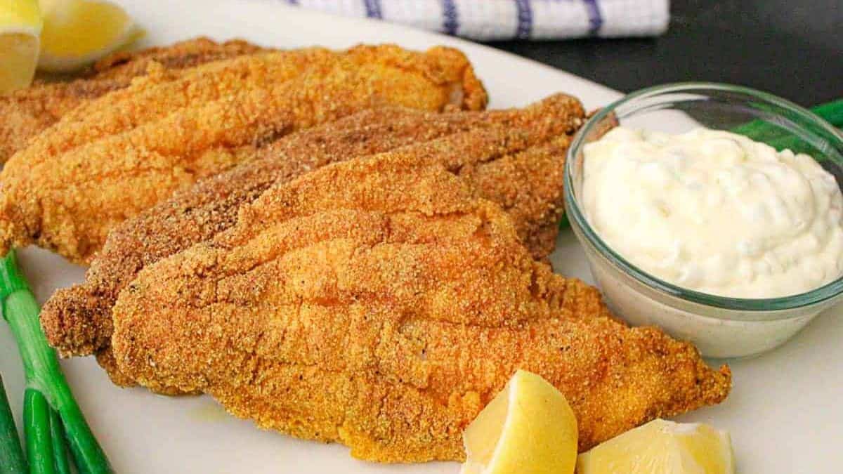 Southern fried catfish with dipping sauce on the side.