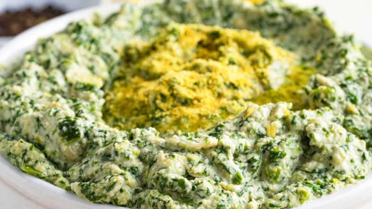 Bowl of freshly made vegan spinach and artichoke dip.