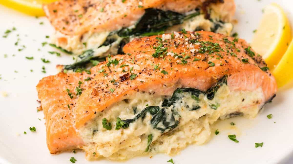 Freshly cooked stuffed salmon in a white plate.