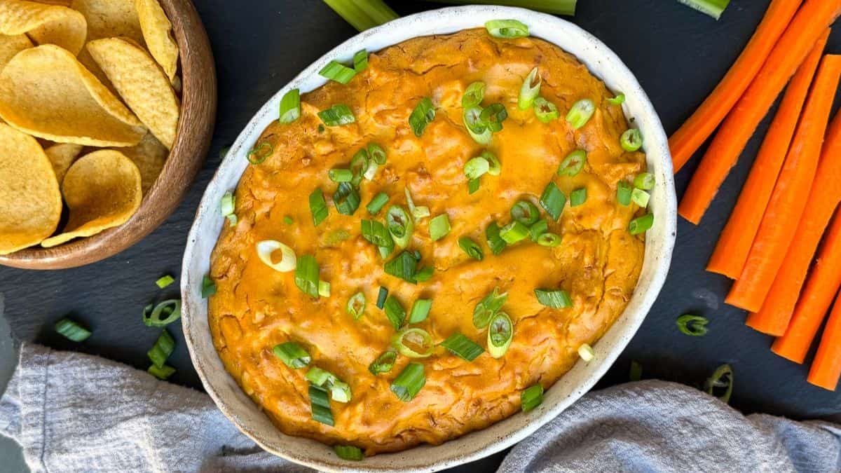 Full serving of vegan buffalo chicken dip topped with green onions.