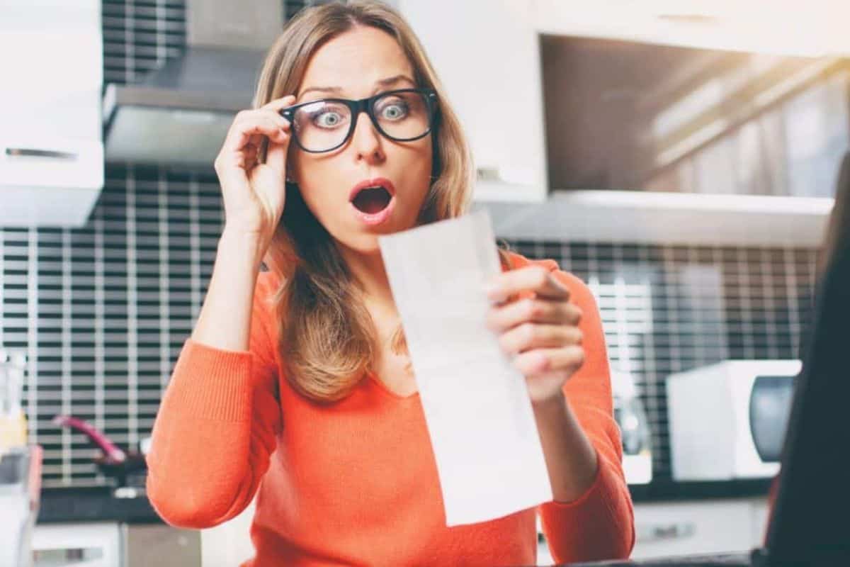 Woman looking at grocery bill in shock