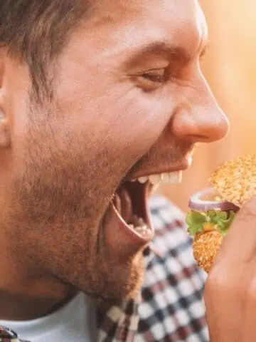 man eating burger