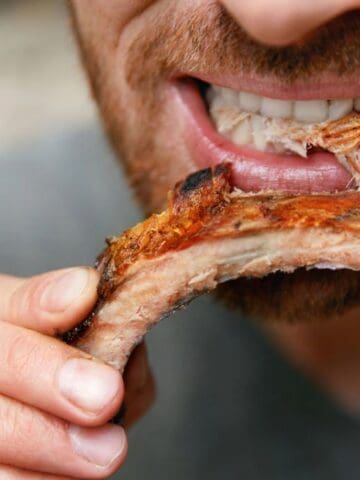 man eating ribs