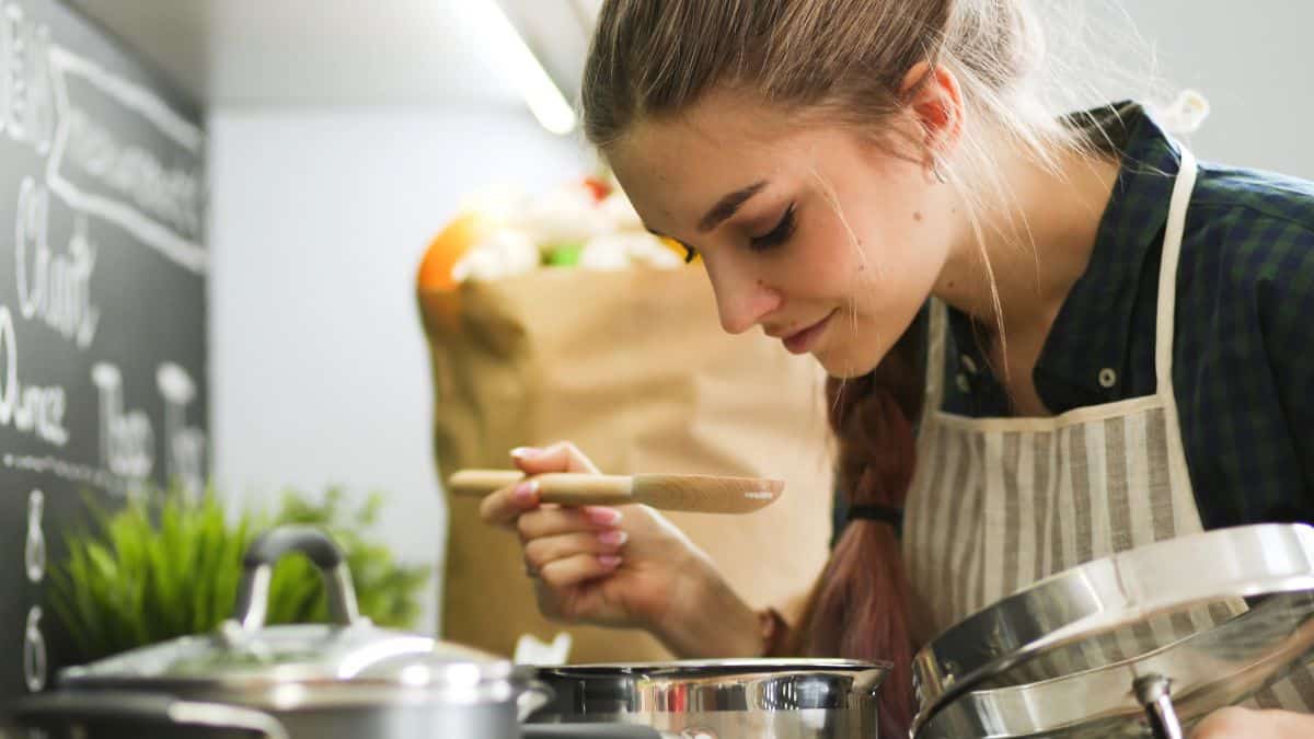 woman cooking with soup pot