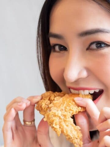 woman eating fried chicken