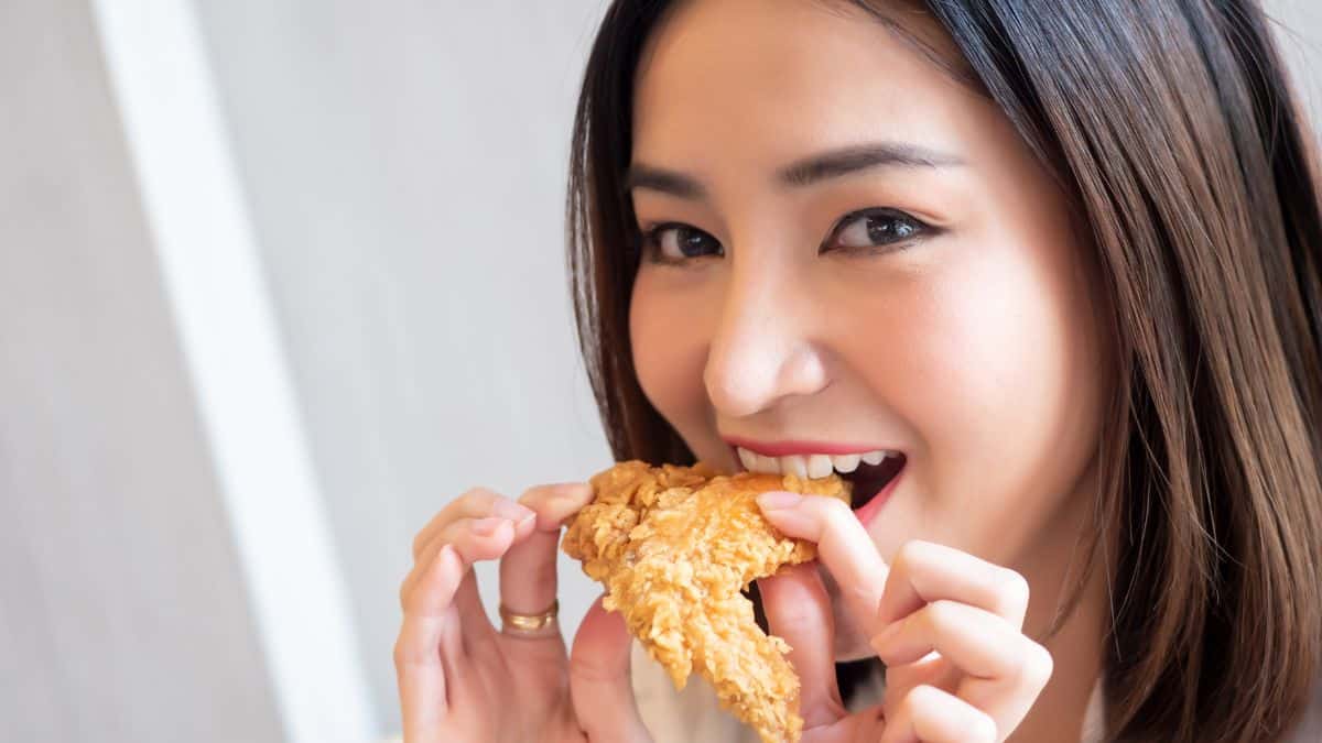 woman eating fried chicken