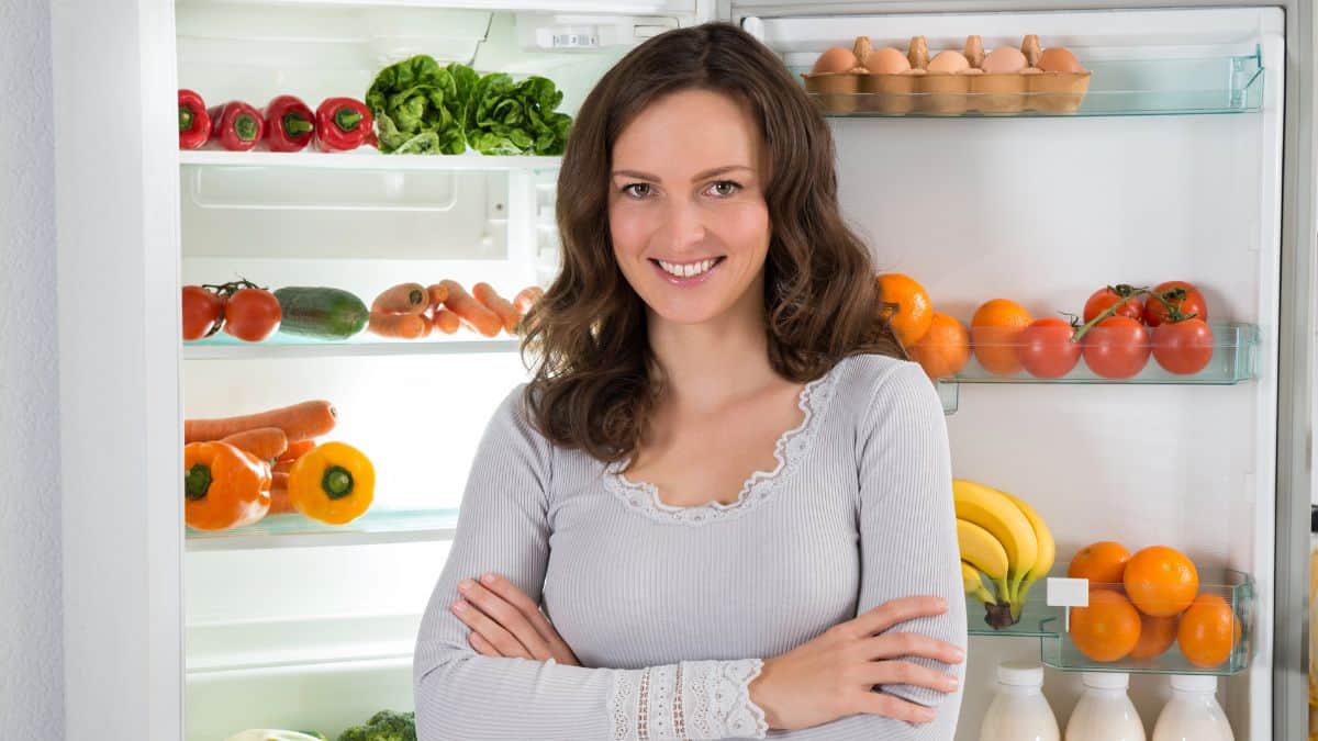 woman standing with fridge open