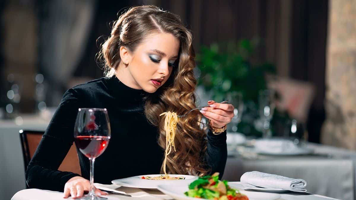 woman with wine eating out