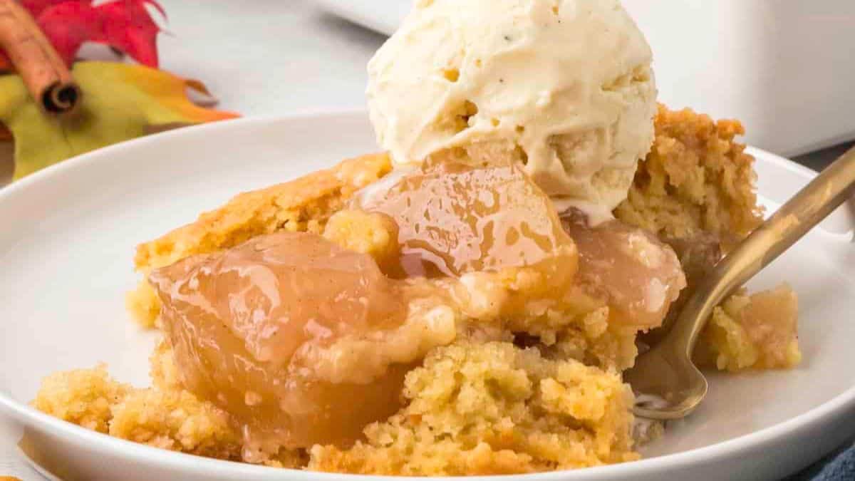 A serving of apple cobbler made with cake mix recipe with ice cream on top.