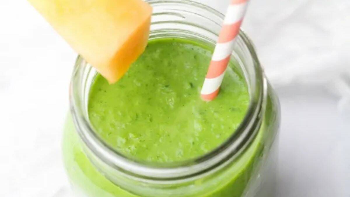 A glass of cantaloupe kale smoothie.