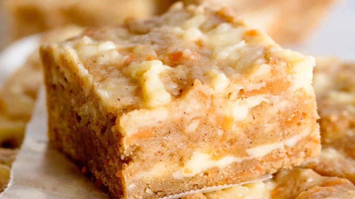 Carrot cake cheesecake cut in squares.