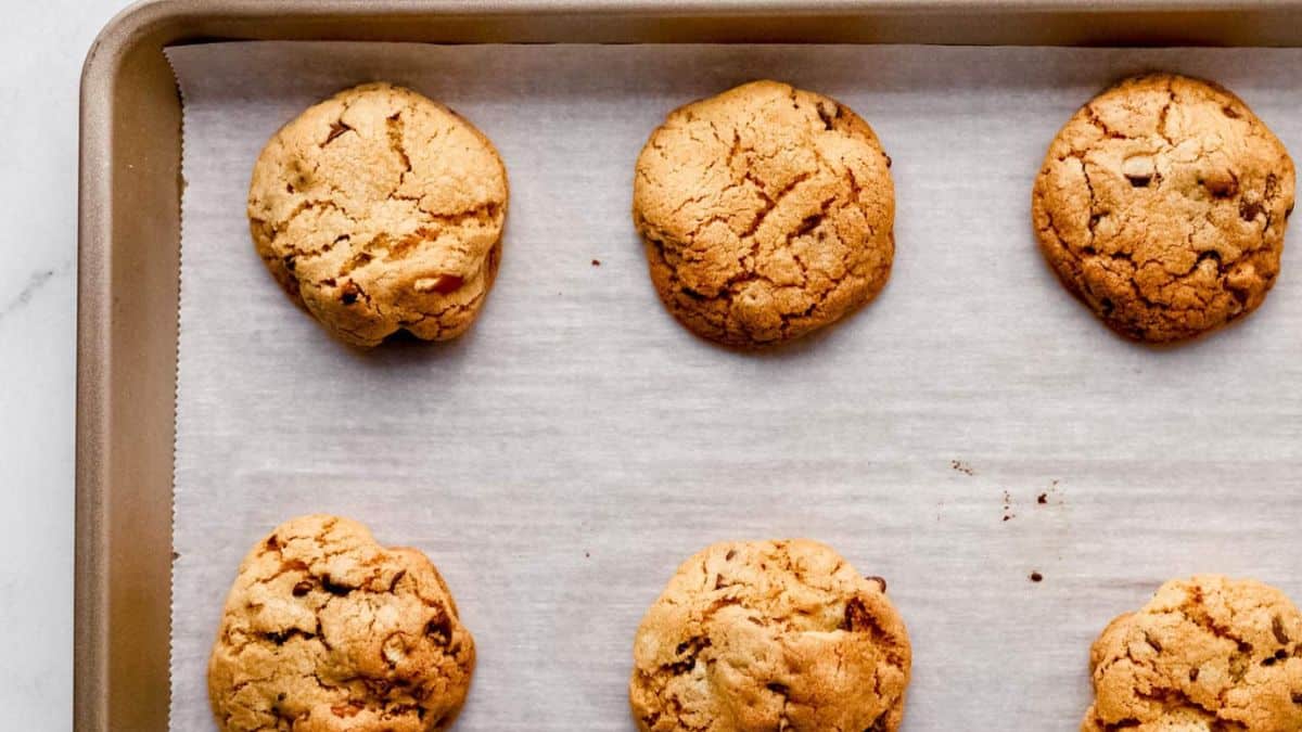 A couple of chocolate chip pretzel cookies in a baking sheet.