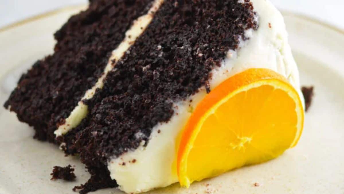 A slice of the chocolate orange cake with orange frosting. 