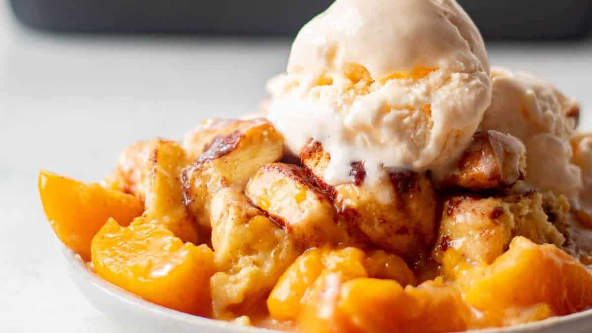 A serving of cinnamon rolls peach cobbler 