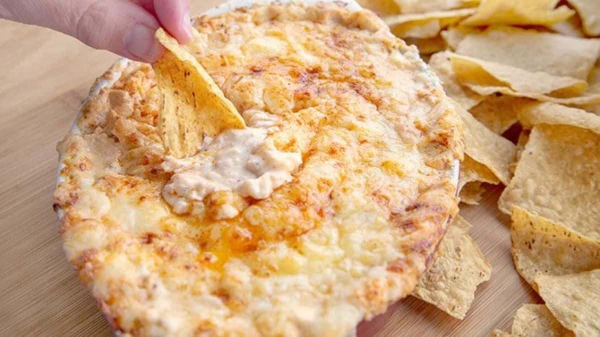 A bowl of creamy cheesy cheddar lobster dip.
