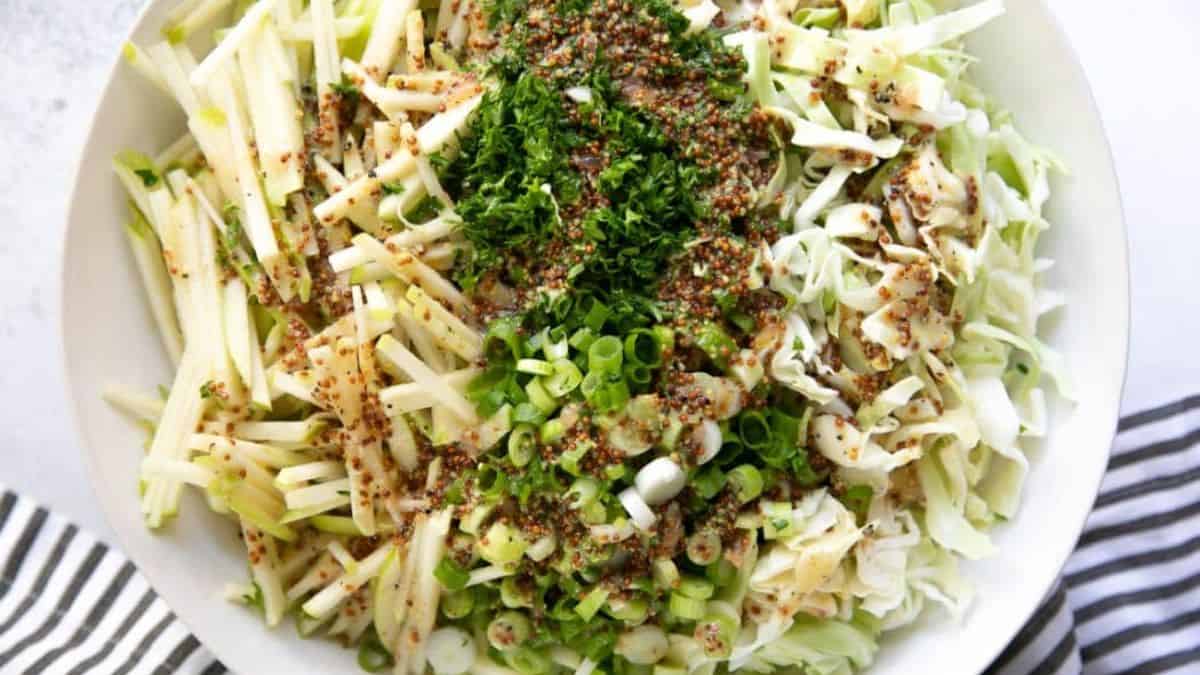 A bowl of crunchy apple coleslaw recipe.