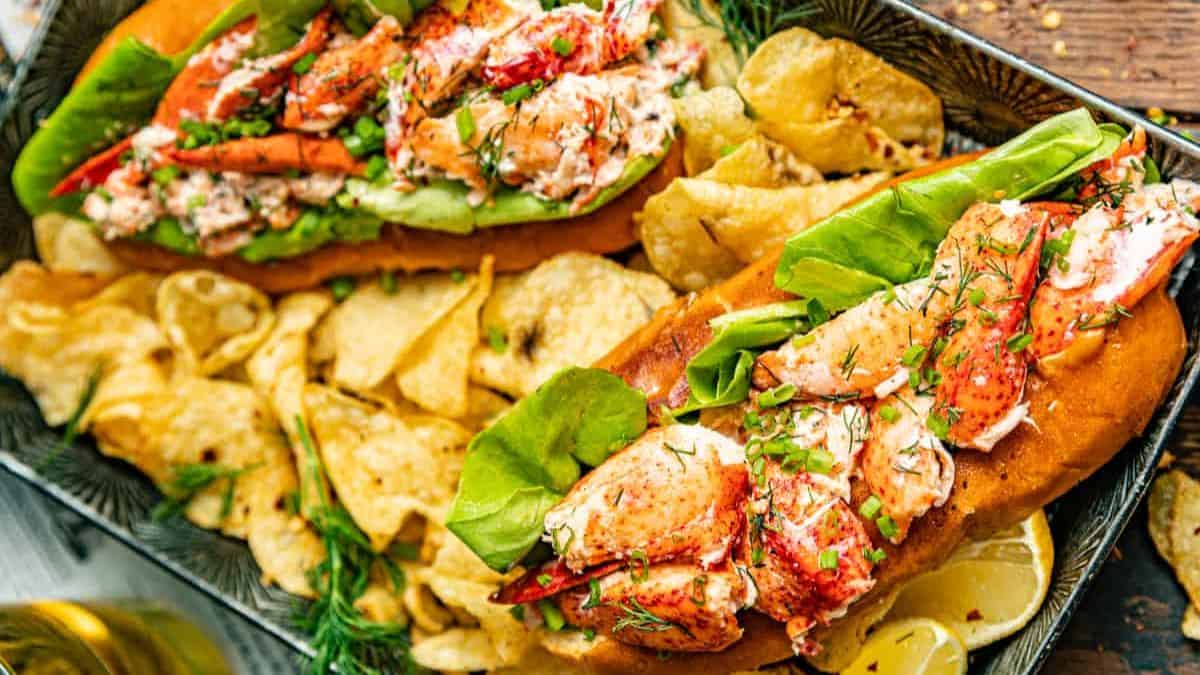 Lobster roll on a bun with chips.