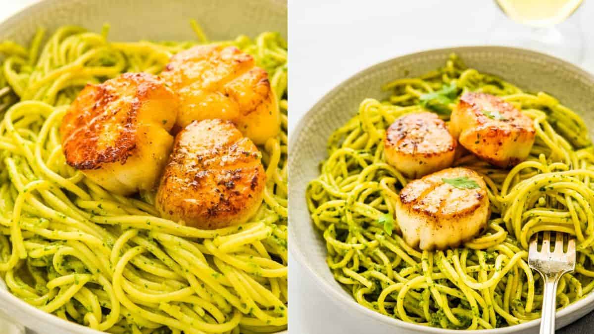 Pesto pasta topped with pan fried scallops served in a plate and a fork.