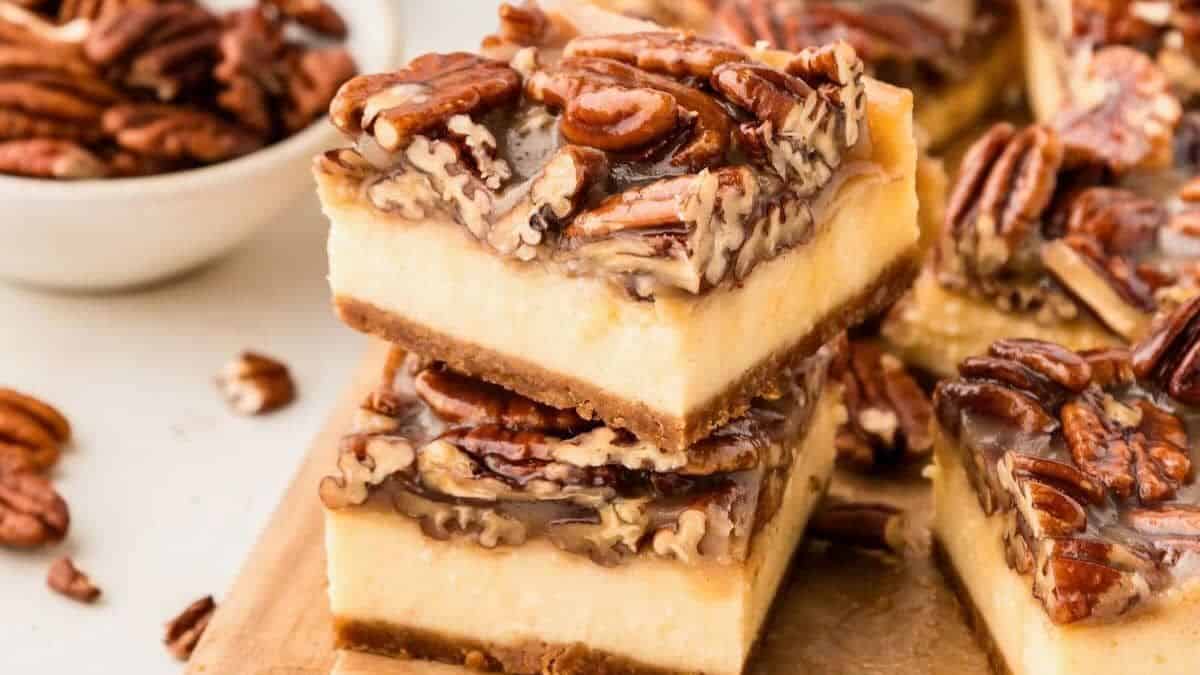 Pecan pie cheesecake bars perfectly cut in squares.