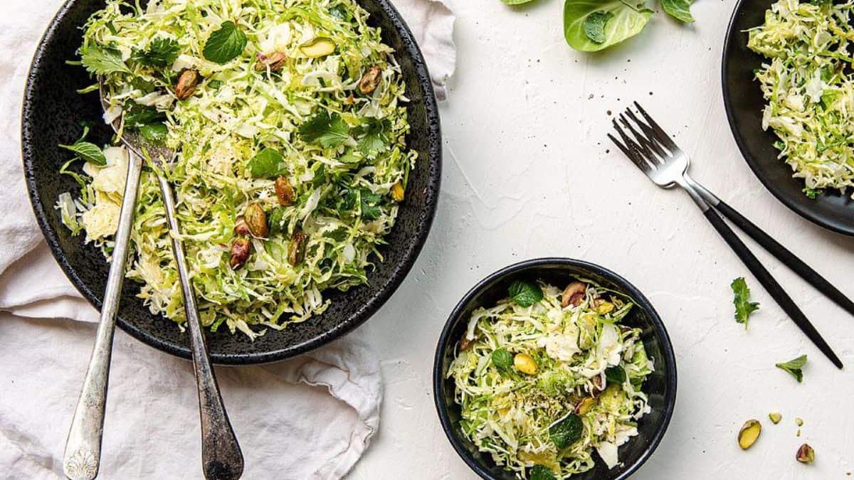 Three bowls of brussels sprout slaw.