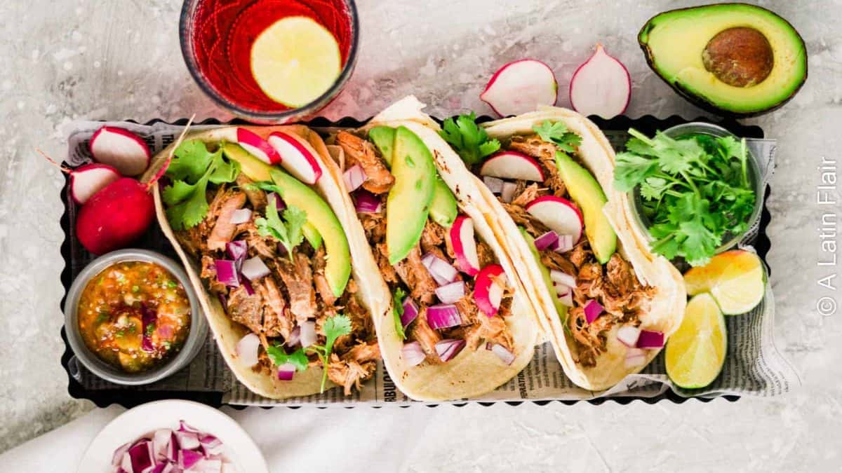Slow cooked pork carnitas street tacos.
