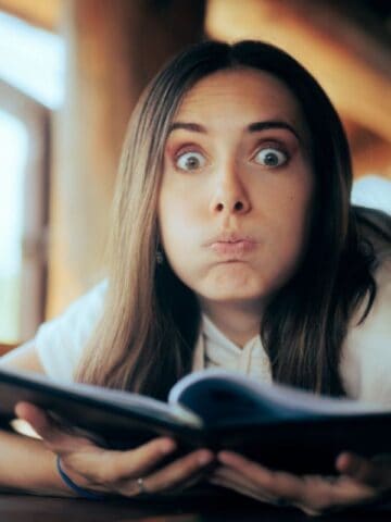 Undecided Woman Checking the Menu in a Restaurant