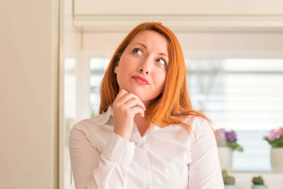 woman thinking, wearing a white shirt