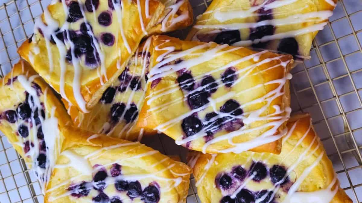 Blueberry Danishes drizzled with glazed sugar.
